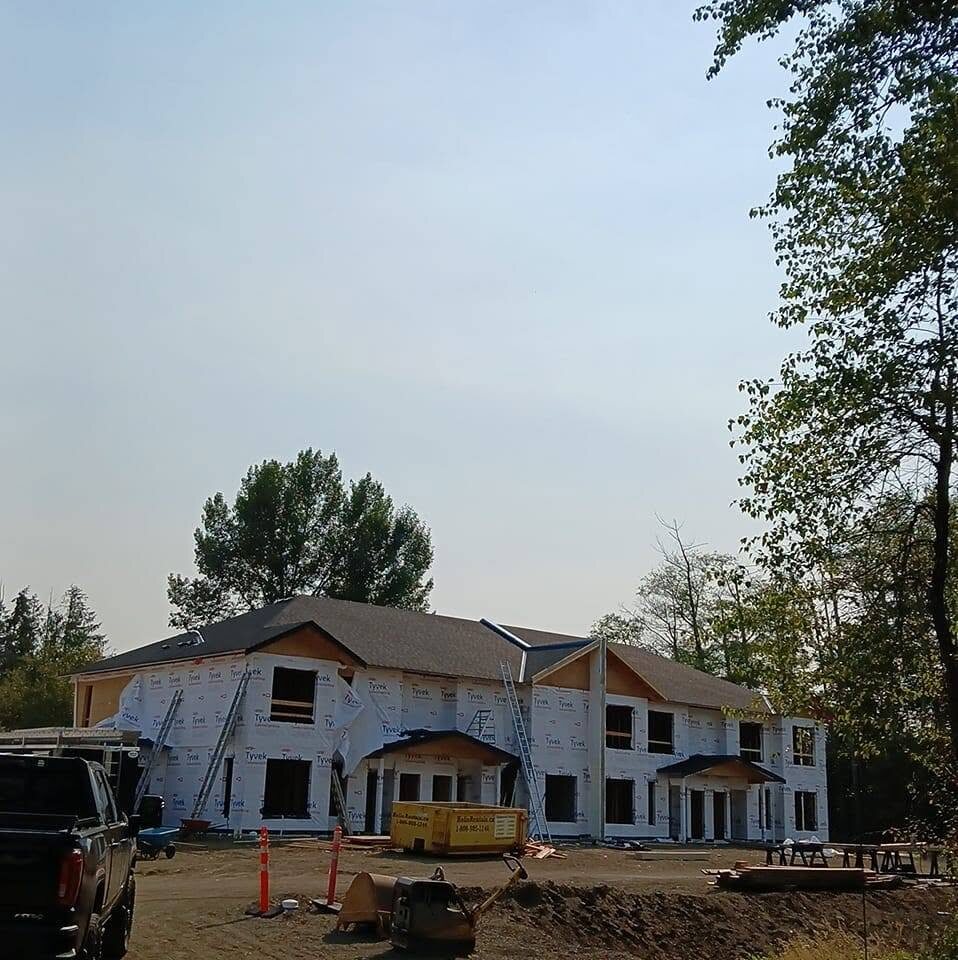 New construction building with roofing and exterior work underway